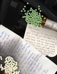 Caroline, a young adult photographer with CRPS, takes a picture of diary entries, letters, and medications that help depict CRPS